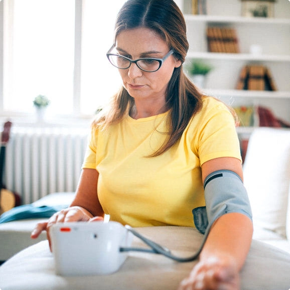Woman with blood pressure monitor