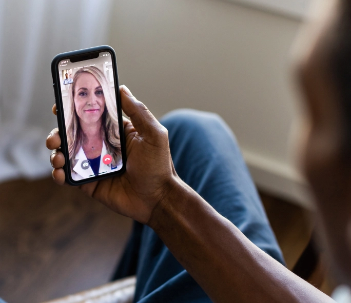 Person looking at their phone during a telemedicine appointment