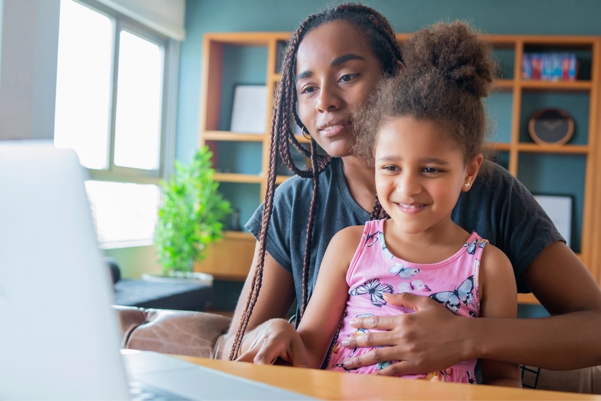 mom with child on virtual call with doctor