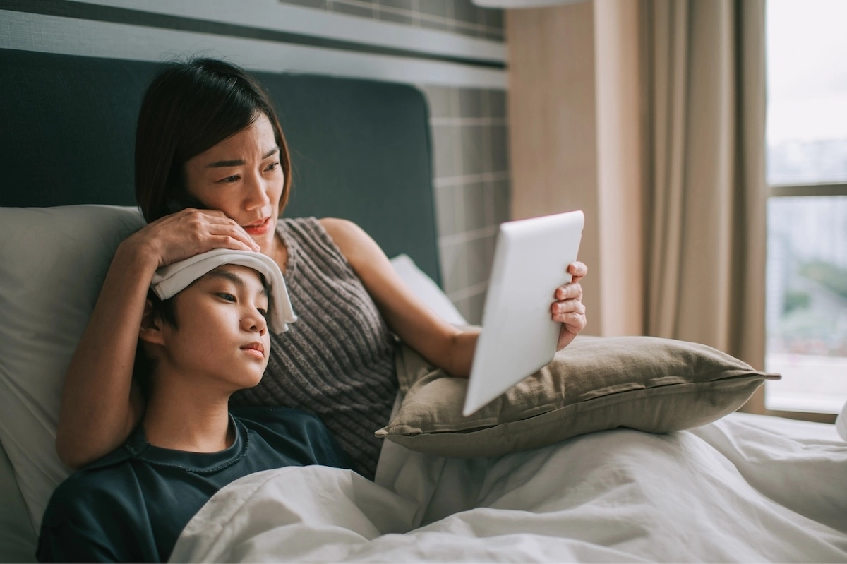 mom and sick in bed using Patient To Prescription urgent care telehealth