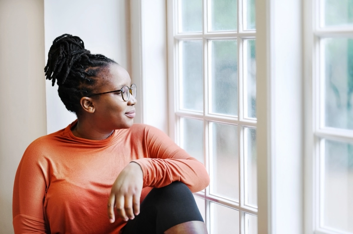 woman looking out window smiling