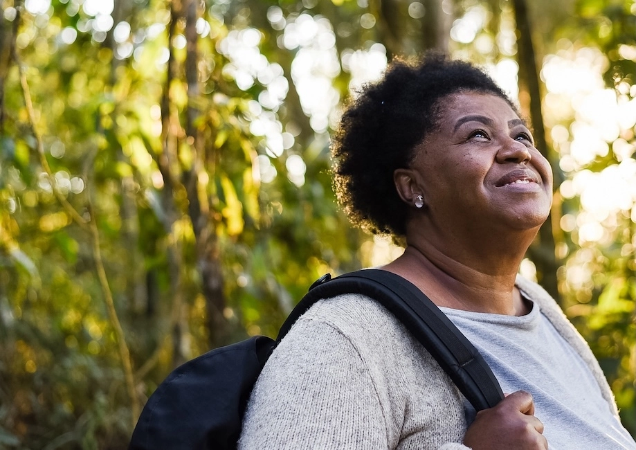 woman outside hiking looking up